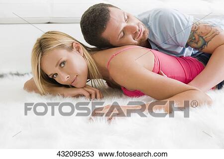 Side profile of a couple resting on a rug View Large Photo Image Stock Image - Side profile of a couple resting on a rug. Fotosearch