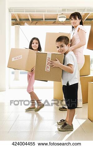 Side profile of a family carrying cardboard boxes View Large Photo Image Stock Photography - Side profile of a family carrying cardboard boxes. Fotosearch