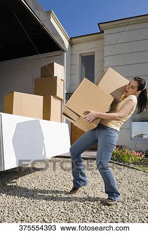 Side profile of a mature woman carrying cardboard boxes View Large Photo Image Stock Image - Side profile of a mature woman carrying cardboard boxes. Fotosearch