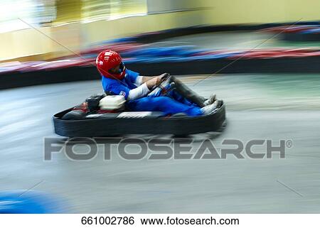 Side profile of a person go-carting on a motor racing track View Large Photo Image Stock Photograph - Side profile of a person go-carting on a motor racing track. Fotosearch