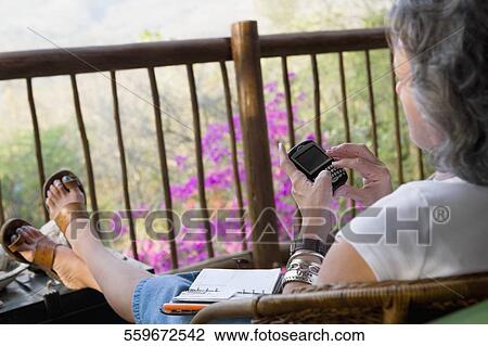 Side profile of a senior woman using a calculator View Large Photo Image Stock Image - Side profile of a senior woman using a calculator. Fotosearch