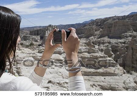 Side profile of a woman photographing with a digital camera View Large Photo Image Stock Photography - Side profile of a woman photographing with a digital camera. Fotosearch