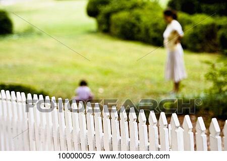 Side profile of a woman with her child in a lawn View Large Photo Image Stock Photo - Side profile of a woman with her child in a lawn. Fotosearch