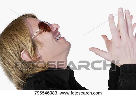 Side profile of a young man praying and smiling View Large Photo Image Stock Image - Side profile of a young man praying and smiling. Fotosearch