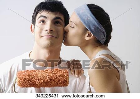 Side profile of a young woman kissing a young man View Large Photo Image Stock Image - Side profile of a young woman kissing a young man. Fotosearch