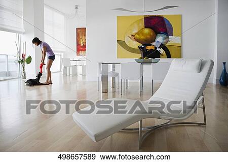 Side profile of a young woman playing with a dog View Large Photo Image Stock Photo - Side profile of a young woman playing with a dog. Fotosearch