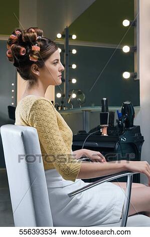 Side profile of a young woman sitting in an armchair View Large Photo Image Picture - Side profile of a young woman sitting in an armchair. Fotosearch