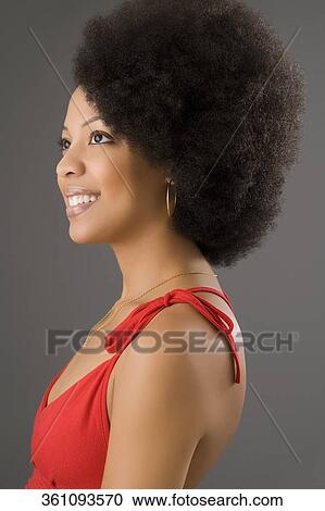 Side profile of a young woman smiling View Large Photo Image Stock Image - Side profile of a young woman smiling. Fotosearch