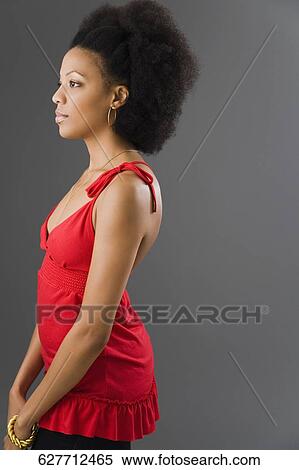 Side profile of a young woman standing and thinking View Large Photo Image Stock Photography - Side profile of a young woman standing and thinking. Fotosearch