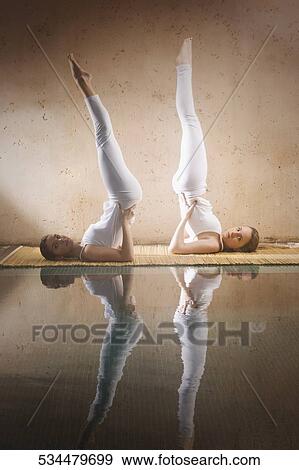 Side profile of two young women exercising at the poolside View Large Photo Image Stock Photo - Side profile of two young women exercising at the poolside. Fotosearch