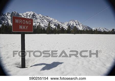 Sign post on a snow covered field with mountains in the background, Grand Teton National Park, Wyoming, USA View Large Photo Image Picture - Sign post on a snow covered field with mountains in the background, Grand Teton National Park, Wyoming, USA. Fotosearch