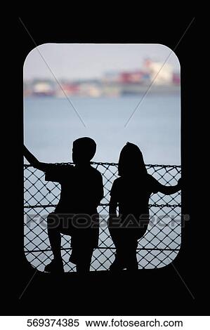 Silhouette of a boy with his sister standing at a door, Hudson River, New York City, New York State, USA View Large Photo Image Stock Photography - Silhouette of a boy with his sister standing at a door, Hudson River, New York City, New York State, USA. Fotosearch