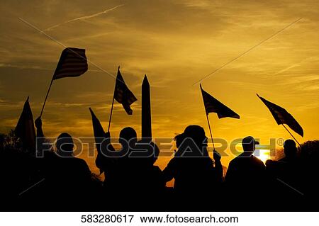 Silhouette of a group of people holding American flag at sunset, Washington Monument, Washington DC, USA View Large Photo Image Stock Photo - Silhouette of a group of people holding American flag at sunset, Washington Monument, Washington DC, USA. Fotosearch
