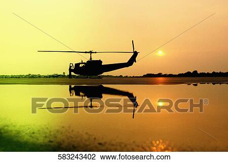 Silhouette of a helicopter at a lakeside View Large Photo Image Stock Image - Silhouette of a helicopter at a lakeside. Fotosearch