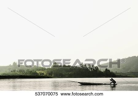 Silhouette of a person rowing a boat, Chiang Rai, Amphoe Mueang, Chiang Rai Province, Thailand View Large Photo Image Stock Photography - Silhouette of a person rowing a boat, Chiang Rai, Amphoe Mueang, Chiang Rai Province, Thailand. Fotosearch