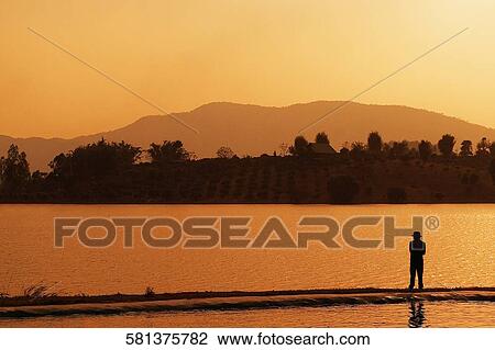Silhouette of a person standing, Chiang Rai, Amphoe Mueang, Chiang Rai Province, Thailand View Large Photo Image Stock Image - Silhouette of a person standing, Chiang Rai, Amphoe Mueang, Chiang Rai Province, Thailand. Fotosearch