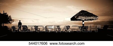 Stock Photograph - Silhouette of a person standing on the beach, Lake Mead, Utah, USA. Fotosearch