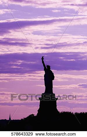 Stock Photo - Silhouette of a statue, Statue of Liberty, Liberty Island, New York City, New York State, USA. Fotosearch