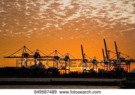Silhouette of cranes at a commercial dock at dusk, Port Of Miami-Dade, Miami, Florida, USA View Large Photo Image Stock Photo - Silhouette of cranes at a commercial dock at dusk, Port Of Miami-Dade, Miami, Florida, USA. Fotosearch