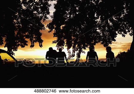Silhouette of four people at dusk, Tahiti, French Polynesia View Large Photo Image Stock Photograph - Silhouette of four people at dusk, Tahiti, French Polynesia. Fotosearch
