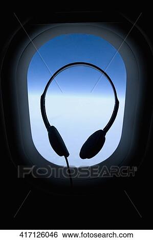 Silhouette of headphones in an airplane View Large Photo Image Stock Photograph - Silhouette of headphones in an airplane. Fotosearch