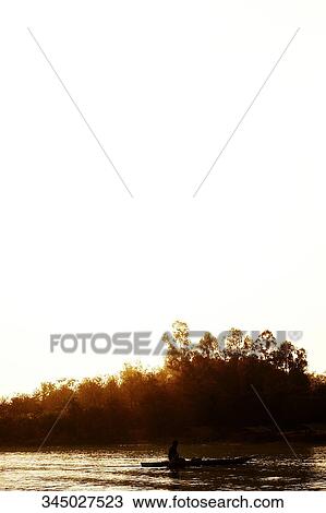 Silhouette of two people in a boat at sunset, Chiang Rai, Amphoe Mueang, Chiang Rai Province, Thailand View Large Photo Image Stock Image - Silhouette of two people in a boat at sunset, Chiang Rai, Amphoe Mueang, Chiang Rai Province, Thailand. Fotosearch