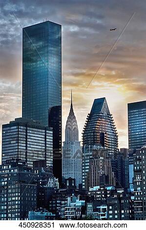 Stock Image - Skyscraper lit up at dusk, Chrysler Building, Manhattan, New York City, New York State, USA. Fotosearch