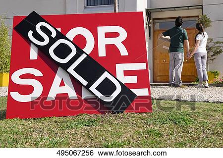 Sold information board in front of a house View Large Photo Image Stock Photograph - Sold information board in front of a house. Fotosearch