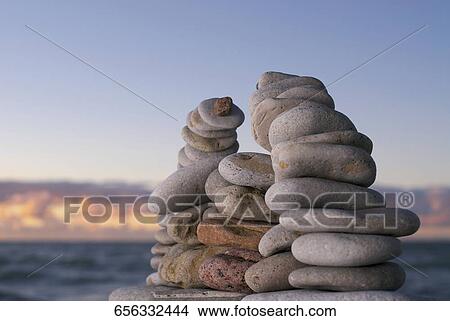Picture - Stacks of pebbles on the beach. Fotosearch