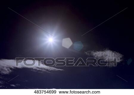 Stock Photo - Sun shining in the sky, Iceland. Fotosearch