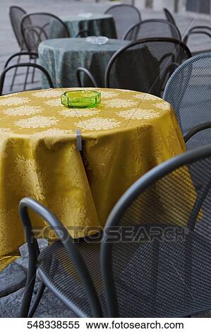 Stock Photography - Tables and chairs in a sidewalk cafe, Naples, Naples Province, Campania, Italy. Fotosearch