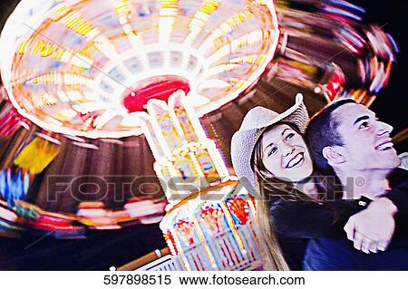 Teenage girl embracing a teenage boy in an amusement park and smiling View Large Photo Image Stock Photography - Teenage girl embracing a teenage boy in an amusement park and smiling. Fotosearch