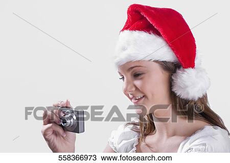 Teenage girl taking picture with a digital camera and smiling View Large Photo Image Stock Image - Teenage girl taking picture with a digital camera and smiling. Fotosearch