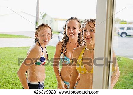 Teenage girls standing together and smiling View Large Photo Image Stock Image - Teenage girls standing together and smiling. Fotosearch