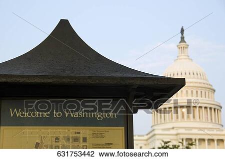 Stock Image - Text on a building with a government building in the background, State Capitol Building, The Mall, Washington DC, USA. Fotosearch