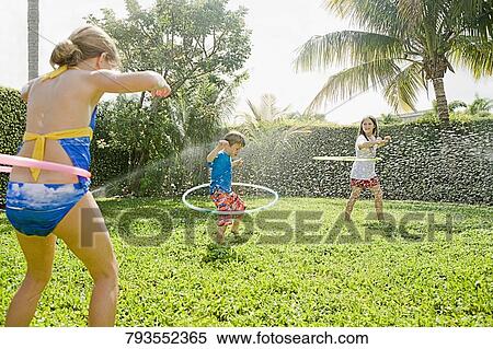 Three friends playing in a lawn View Large Photo Image Stock Photography - Three friends playing in a lawn. Fotosearch