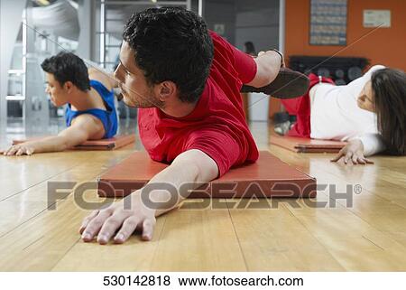 Three people in an aerobics class View Large Photo Image Stock Photo - Three people in an aerobics class. Fotosearch