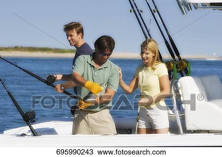 Stock Image - Tourists fishing in the sea. Fotosearch