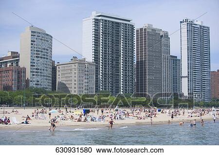Tourists on the beach, Oak Street Beach, Lake Shore Drive, Chicago, Illinois, USA View Large Photo Image Stock Image - Tourists on the beach, Oak Street Beach, Lake Shore Drive, Chicago, Illinois, USA. Fotosearch