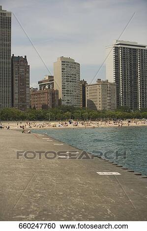 Tourists on the beach, Oak Street Beach, Lake Shore Drive, Chicago, Illinois, USA View Large Photo Image Stock Image - Tourists on the beach, Oak Street Beach, Lake Shore Drive, Chicago, Illinois, USA. Fotosearch