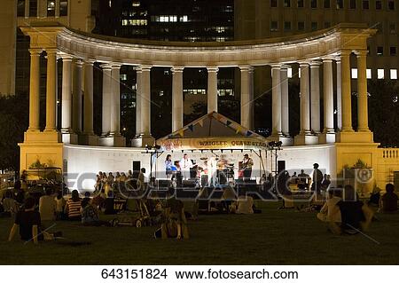 Tourists sitting at an auditorium, Jay Pritzker Pavillion, Millennium Park, Chicago, Illinois, USA View Large Photo Image Picture - Tourists sitting at an auditorium, Jay Pritzker Pavillion, Millennium Park, Chicago, Illinois, USA. Fotosearch