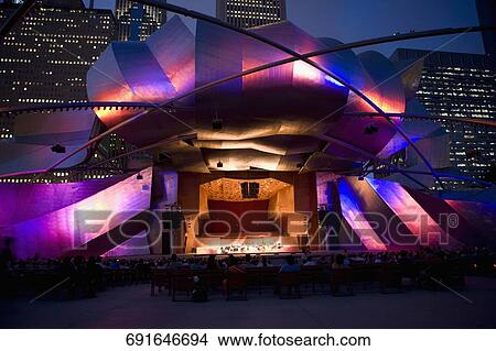 Picture - Tourists sitting outside an auditorium, Jay Pritzker Pavillion, Millennium Park, Chicago, Illinois, USA. Fotosearch