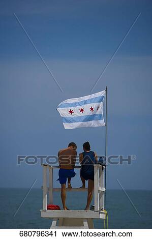 Tourists standing on a lifeguard hut, Oak Street Beach, 1000 North Lake Shore Drive, Chicago, Illinois, USA View Large Photo Image Stock Image - Tourists standing on a lifeguard hut, Oak Street Beach, 1000 North Lake Shore Drive, Chicago, Illinois, USA. Fotosearch