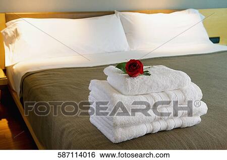 Stock Photograph - Towels on the bed in a hotel room. Fotosearch