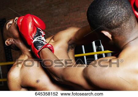 Two boxers fighting in a boxing ring View Large Photo Image Stock Image - Two boxers fighting in a boxing ring. Fotosearch