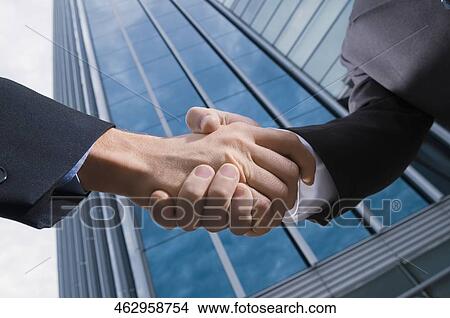 Two businessmen shaking hands View Large Photo Image Picture - Two businessmen shaking hands. Fotosearch