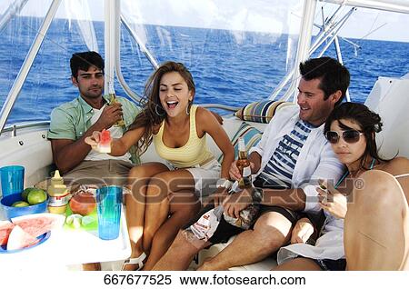 Two couples enjoying beer and fruits in a tourboat View Large Photo Image Stock Photography - Two couples enjoying beer and fruits in a tourboat. Fotosearch