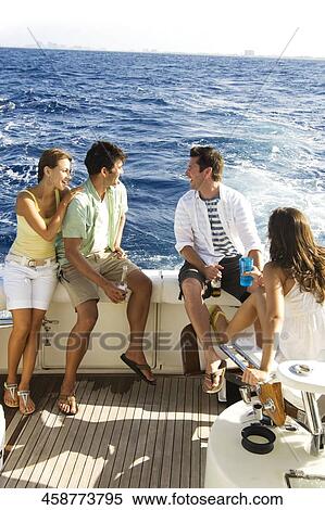 Two couples enjoying beer in a tourboat View Large Photo Image Stock Photography - Two couples enjoying beer in a tourboat. Fotosearch