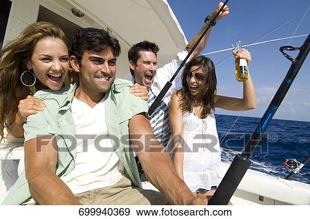 Two couples sitting in a boat and fishing View Large Photo Image Stock Photo - Two couples sitting in a boat and fishing. Fotosearch