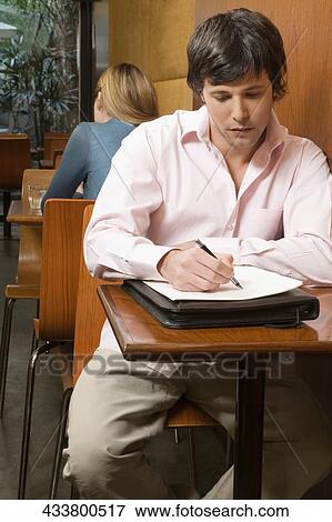 Two customers sitting in a cafe View Large Photo Image Stock Photo - Two customers sitting in a cafe. Fotosearch